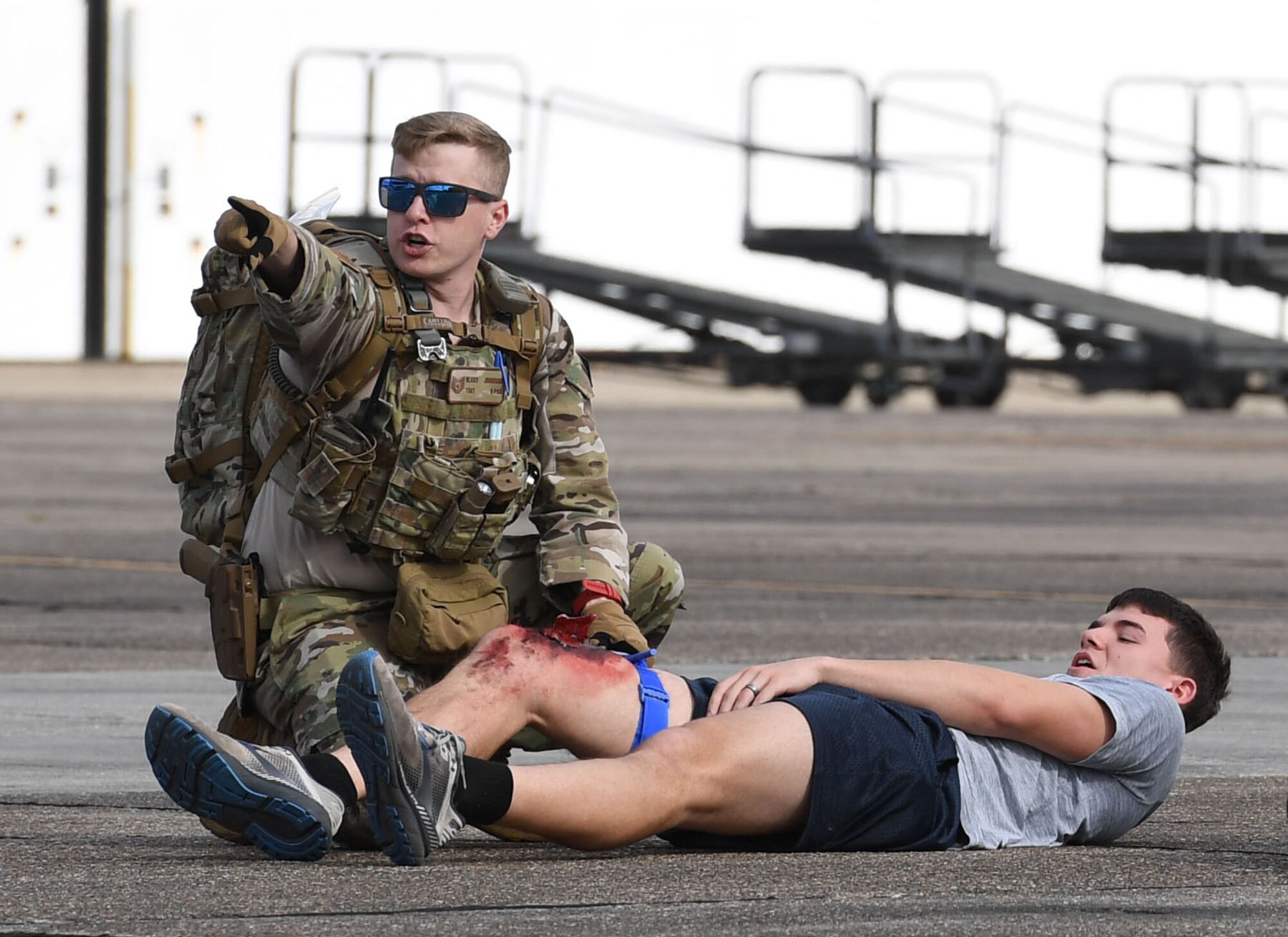 U.S. Air Force Tech. Sgt. Blake Johnson, 81st Security Forces Squadron training NCO in charge, administers triage on Airman Cameron Raney, 336th Training Squadron student, during the aircraft mishap exercise at Keesler Air Force Base, Mississippi, March 16, 2023.