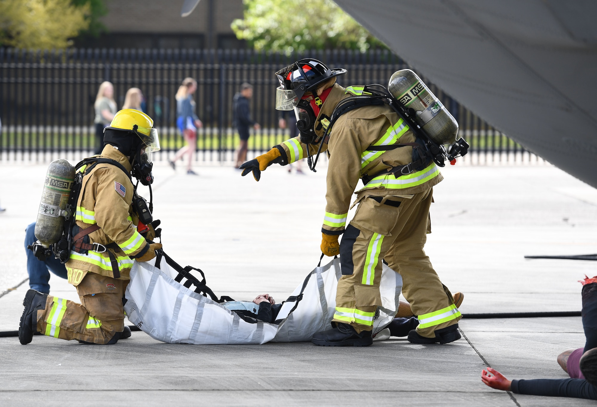 Members of the Keesler Fire Department prepare to transport a simulated patient to the triage area during the aircraft mishap exercise at Keesler Air Force Base, Mississippi, March 16, 2023.