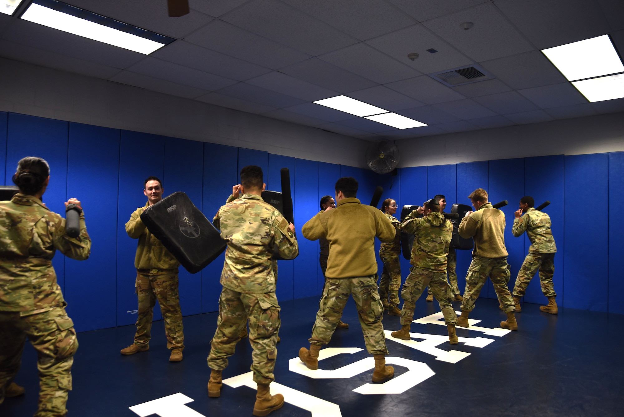 Team McChord Airmen practice their combat fighting skills during a mock training with the 627th Security Forces Squadron at Joint Base Lewis-McChord, Washington, March 14, 2023. During their visit the Airmen learned about the Security Forces Squadron and what they do daily. The Airmen Experience tour is an opportunity for new Team McChord Airmen to learn about how each unit operates within the command. (U.S. Air Force photo by Airman Kylee Tyus)