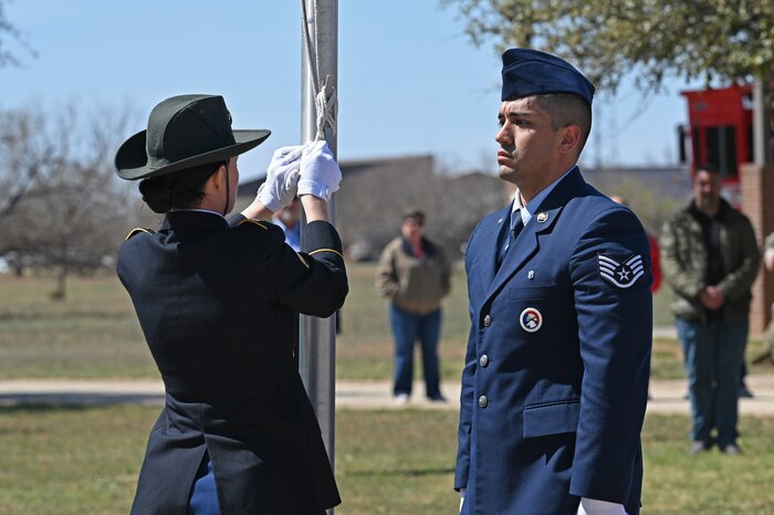 Members of the joint service color guard lower a flag to half-staff during the annual Department of Defense Fallen Firefighter Memorial Service, Goodfellow Air Force Base, Texas, March 17, 2023. Lowering the flag to half-staff is a sign of grief or mourning. (U.S. Air Force photo by Senior Airman Ashley Thrash)
