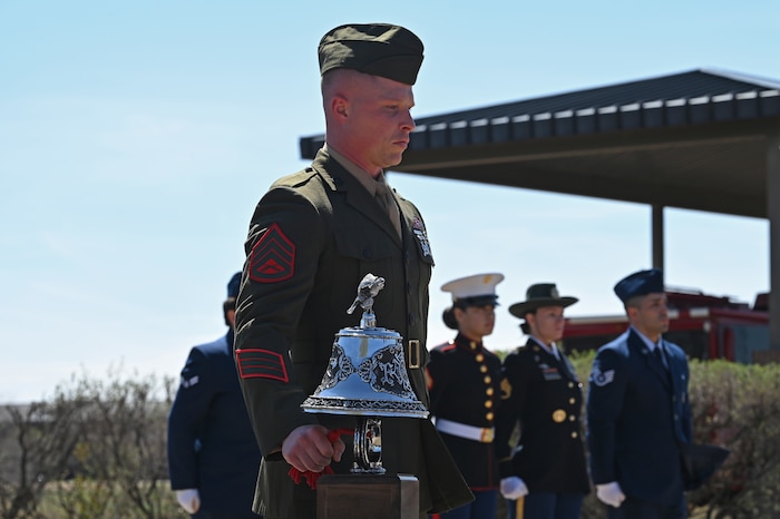U.S. Marine Corps Staff Sgt. Isaac Ross, 312th Training Squadron instructor, rings the ceremonial bell during the final call at the annual Department of Defense Fallen Firefighter Memorial Service, Goodfellow Air Force Base, Texas, March 17, 2023. The ceremonial bell was rung five times as a send off to the firefighters that laid down their lives in the line of duty. (U.S. Air Force photo by Senior Airman Ashley Thrash)