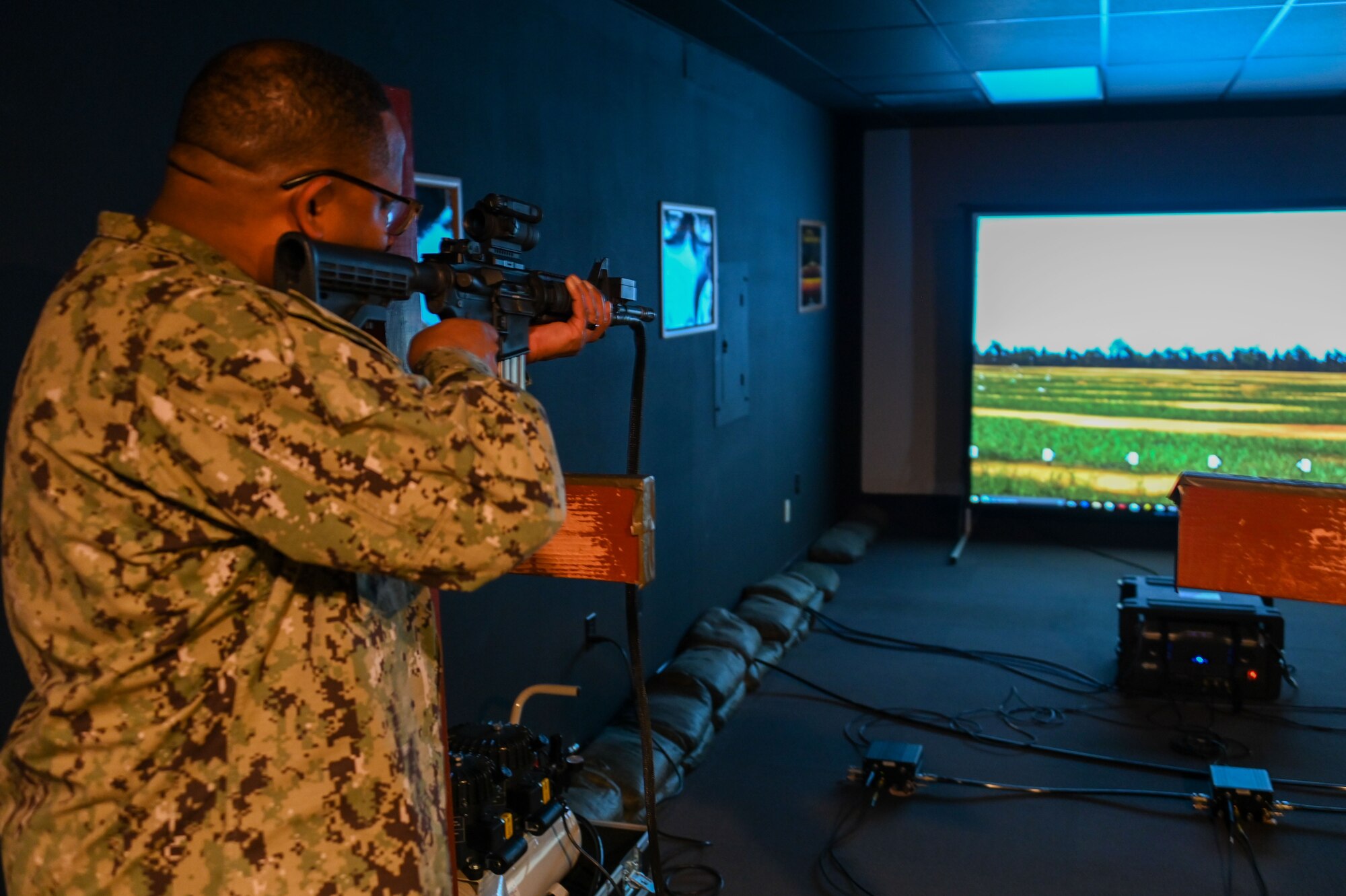 U.S. Navy Fleet Master Chief Donald O. Myrick, U.S. Transportation Command senior enlisted leader, participates in a shooting simulator at Altus Air Force Base, Oklahoma, March 15, 2023. The simulator allows 97th Security Forces Squadron defenders to practice their shooting skills without having to go to an actual shooting range, use ammo and dirty guns. (U.S. Air Force photo by Senior Airman Kayla Christenson)