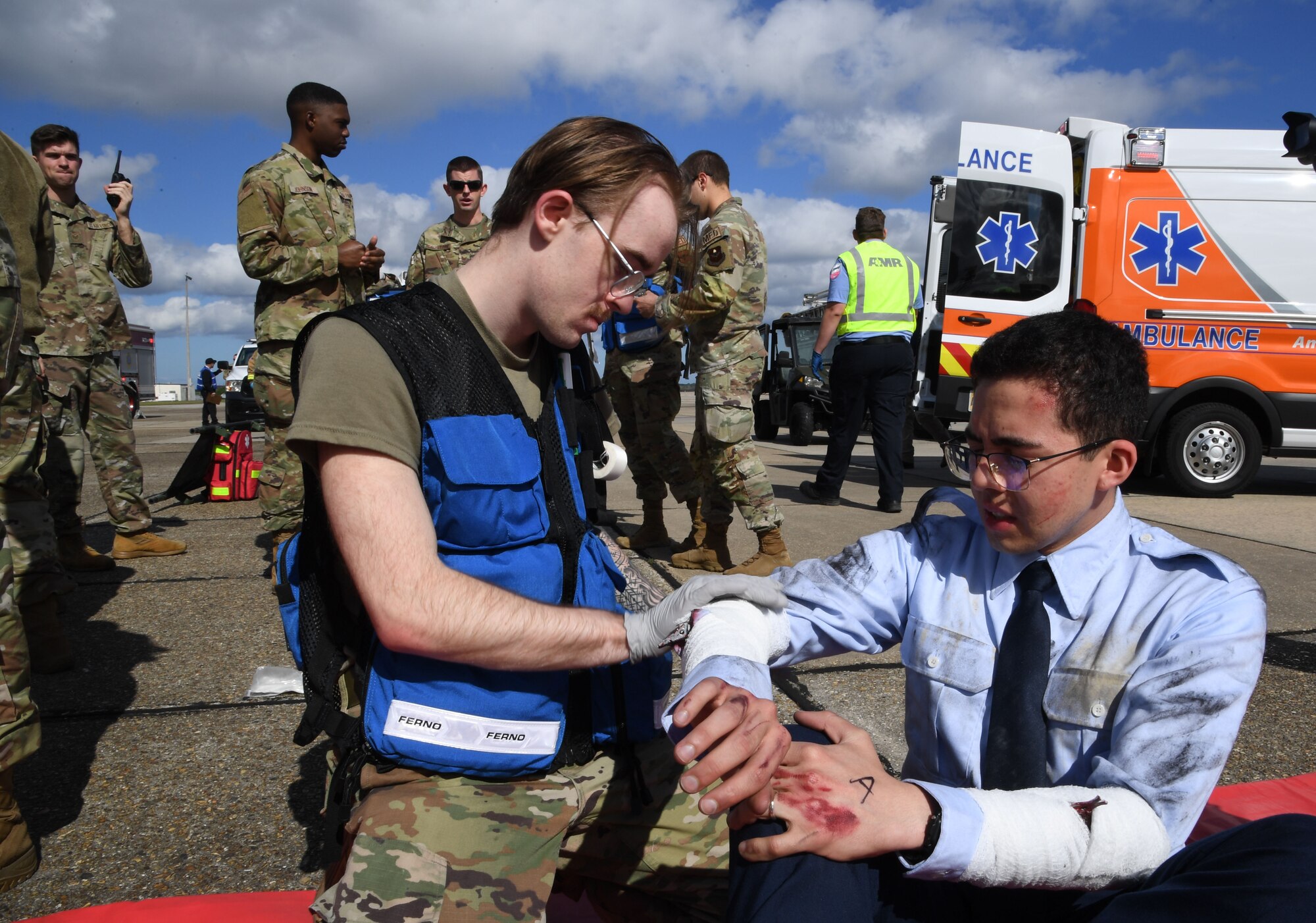 U.S. Air Force Airman 1st Class Tyler Sloan, 81st Operational Medical Readiness Squadron medical technician, wraps a simulated arm wound on Airman Christopher Rivas, 334th Training Squadron student, during the aircraft mishap exercise at Keesler Air Force Base, Mississippi, March 16, 2023.