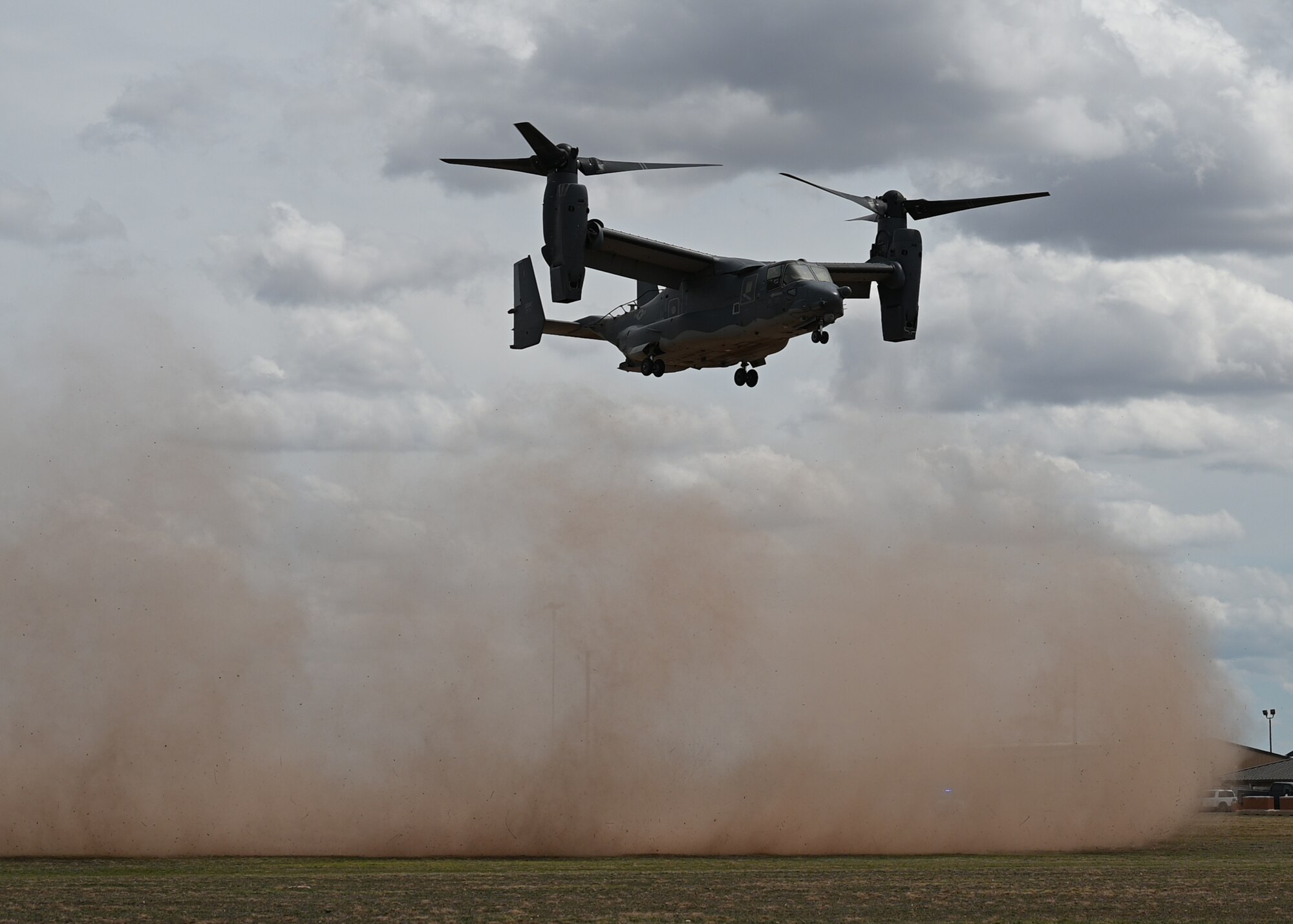 A CV-22 Osprey lands in a field at Goodfellow Air Force Base, Texas, Mar. 16, 2023. The CV-22 Osprey is a tiltrotor aircraft that combines the vertical takeoff, hover and vertical landing qualities of a helicopter with the long-range, fuel efficiency and speed characteristics of a turboprop aircraft. (U.S. Air Force photo by Airman 1st Class Zachary Heimbuch)