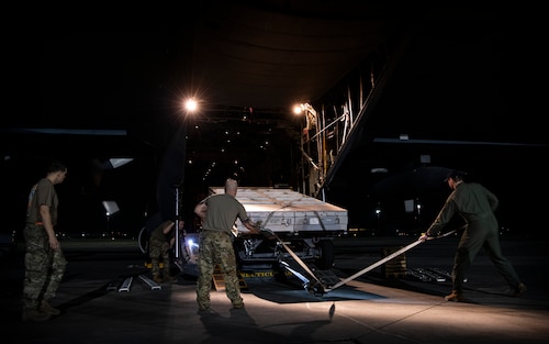 Airmen assigned to the 621st Contingency Response Wing at Travis Air Force Base, California, and 103rd Airlift Wing at Bradley Air National Guard Base, Connecticut, work together to load a Lockheed C-130 Hercules aircraft from Bradley ANGB during AGILE FLAG 23-1 at Savannah Air National Guard Base, Georgia, March 2, 2023. A