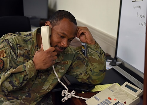 U.S. Air Force Tech. Sgt. Willie Rouse, 17th Training Support Squadron security manager, picks up a phone at Goodfellow Air Force Base, Texas, March 15, 2023. Rouse was originally an imagery analyst but is now the 17th TRSS’s security manager as well as the unit deployment manager, an alternate duty first sergeant, Tactical Combat Casualty Care trainer, and even helps his Airman with unit training manager duties. (U.S. Air Force photo by Senior Airman Sarah Williams)