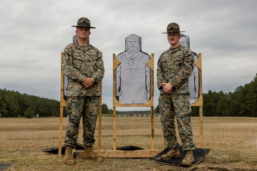 Two Marines pose next to each other for a photo.