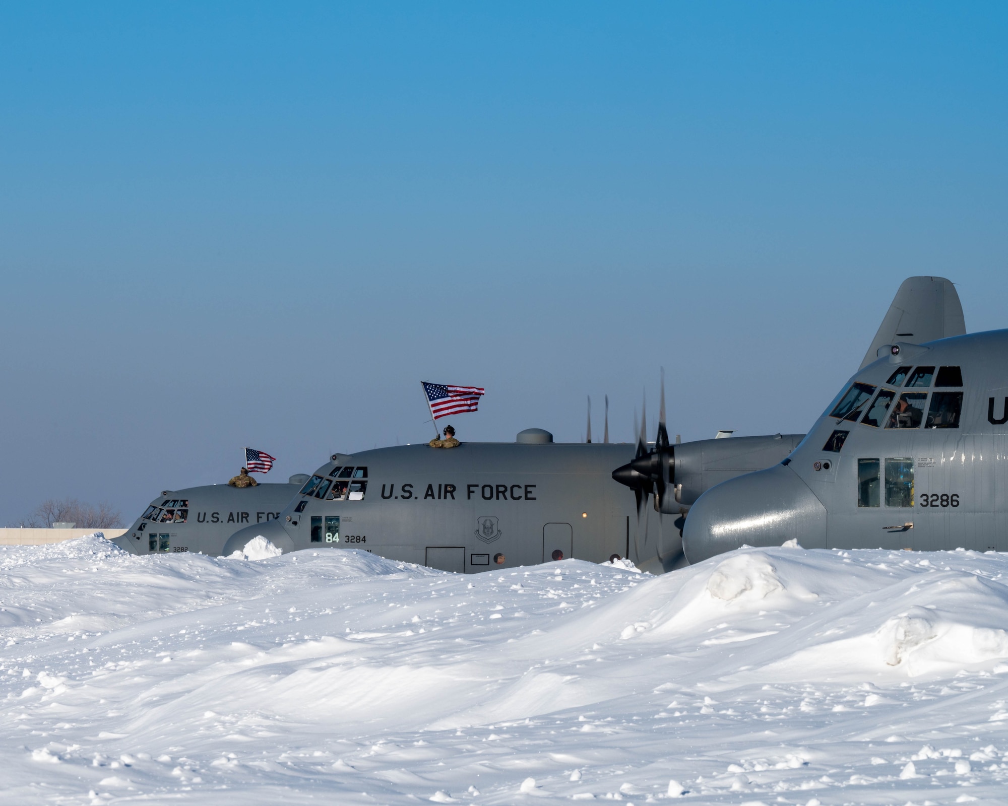 Three 934th Airlift Wing's C-130s line up and wait for take off at Minneapolis-St. Paul Air Reserve Station on Feb. 25, 2023. More than 135 Airmen recently deployed to support Operation East Africa Counter-Terrorism's mission to conduct operations to enhance partner nation capacity, promote regional peace and stability, dissuade conflict, and protect U.S. and coalition interests. (U.S. Air Force photo by Master Sgt. Trevor Saylor)