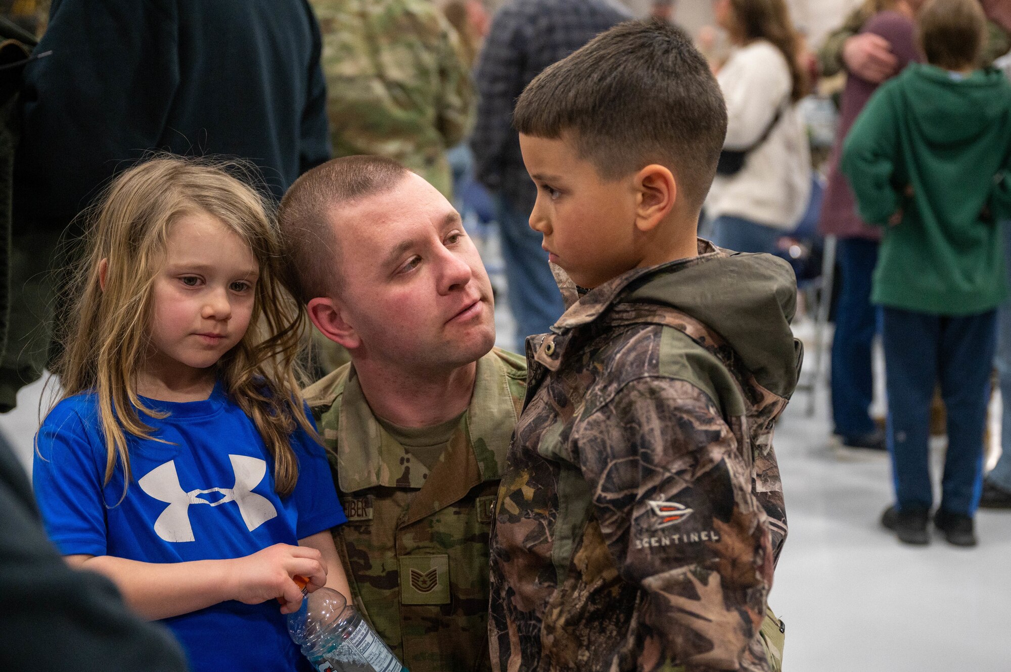 Tech. Sgt. Jeremy Quittschreiber, 96th Airlift Squadron command support staff, spends time with his kids before he deploys to the United States Africa Command's area of operation from Minneapolis-St. Paul Air Reserve Station on Feb. 25, 2023. More than 135 Airmen recently deployed to support Operation East Africa Counter-Terrorism's mission to conduct operations to enhance partner nation capacity, promote regional peace and stability, dissuade conflict, and protect U.S. and coalition interests. (U.S. Air Force photo by Staff Sgt. Timothy Leddick)