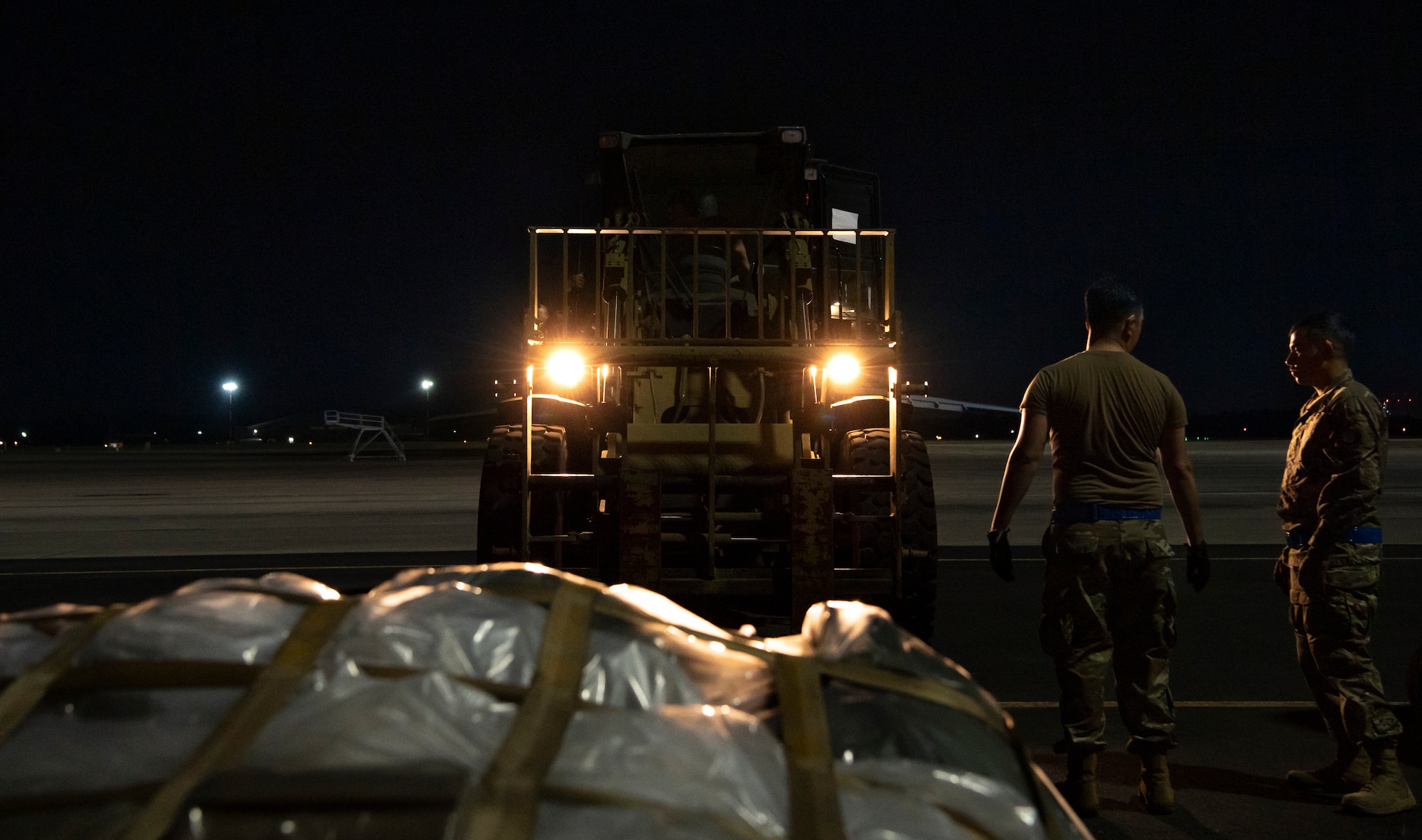 Airmen assigned to the 621st Contingency Response Wing  talk about how to move cargo during AGILE FLAG 23-1 at Savannah Air National Guard Base, Georgia, Feb. 26 2023.