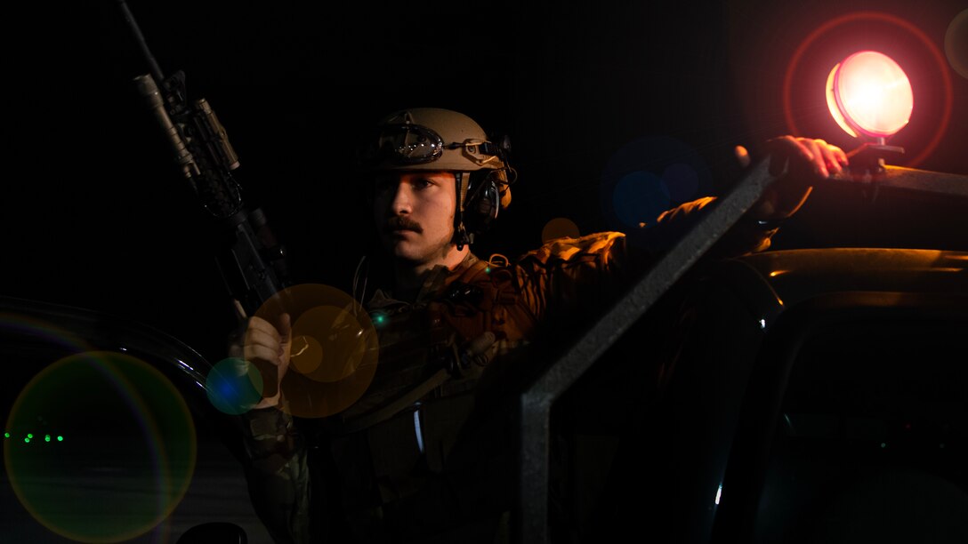 Senior Airman Caleb Carson, a 921st Contingency Response Squadron fire team member, surveys the flight line during AGILE FLAG 23-1 at Savannah Air National Guard Base, Georgia, March 2, 2023.