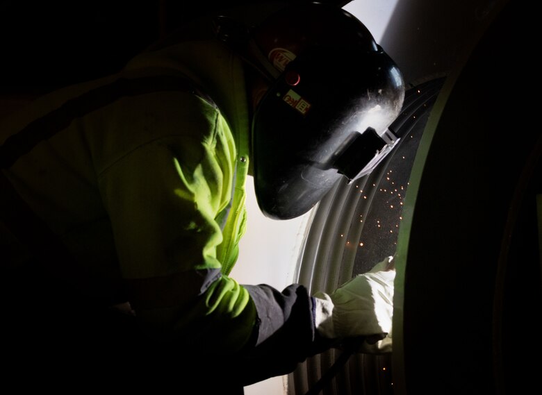 Darion Weber, a contractor with BCI Construction USA, welds wire rope leads to the new gate hoists in the Crooked Creek Dam control tower in Ford City, Pennsylvania, Feb. 14, 2023. BCI Construction installed four new hoists – each weighing 38,000 pounds apiece and control the dam’s gates – at Crooked Creek Lake to modernize the facility’s machinery and improve usage. The new hoists make the machinery safer and more efficient to use, with digital displays that are more accurate and easier to read. The original hoists were in operation since the dam was built in 1938. (U.S. Army Corps of Engineers photo by Andrew Byrne)