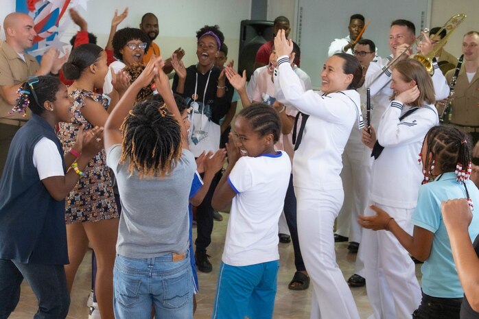 Marines and Sailors dance with students at the Escola Dona Tututa in Sal Island, Cabo Verde, Mar. 18, 2023. Marines and sailors supporting the African Maritime Forces Summit (AMFS), toured Sal Island and met with local students in a unique opportunity to learn about their culture prior to the opening day of the summit on March 20. Hosted by U.S. Naval Forces Europe and Africa (NAVEUR-NAVAF), the African Maritime Forces Summit (AMFS) is a strategic-level forum that brings African maritime and naval infantry leaders together with their international partners to address transnational maritime security challenges within African waters including the Atlantic Ocean, Indian Ocean, and Mediterranean Sea.