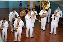 Marines and Sailors perform for students at the Escola Dona Tututa in Sal Island, Cabo Verde, Mar. 18, 2023. Marines and Sailors supporting the African Maritime Forces Summit (AMFS), toured Sal Island and met with local students in a unique opportunity to learn about their culture prior to the opening day of the summit on March 20. Hosted by U.S. Naval Forces Europe and Africa (NAVEUR-NAVAF), the African Maritime Forces Summit (AMFS) is a strategic-level forum that brings African maritime and naval infantry leaders together with their international partners to address transnational maritime security challenges within African waters including the Atlantic Ocean, Indian Ocean, and Mediterranean Sea.