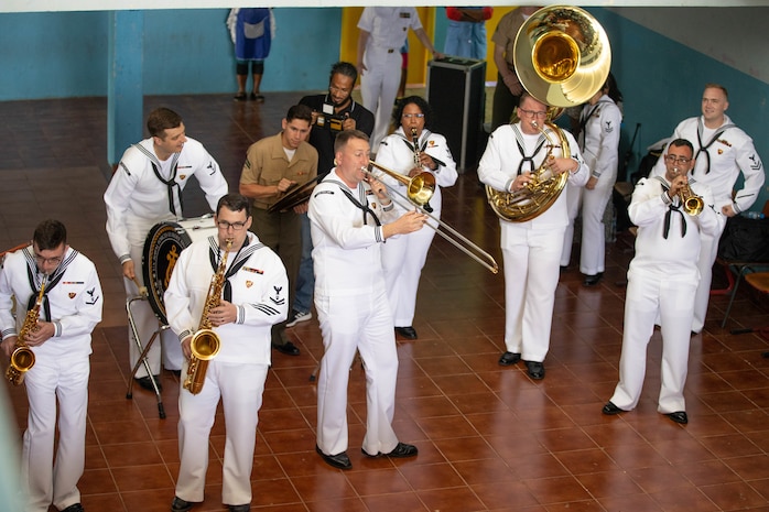 Marines and Sailors perform for students at the Escola Dona Tututa in Sal Island, Cabo Verde, Mar. 18, 2023. Marines and Sailors supporting the African Maritime Forces Summit (AMFS), toured Sal Island and met with local students in a unique opportunity to learn about their culture prior to the opening day of the summit on March 20. Hosted by U.S. Naval Forces Europe and Africa (NAVEUR-NAVAF), the African Maritime Forces Summit (AMFS) is a strategic-level forum that brings African maritime and naval infantry leaders together with their international partners to address transnational maritime security challenges within African waters including the Atlantic Ocean, Indian Ocean, and Mediterranean Sea.