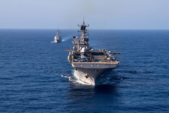 Amphibious assault ship USS Makin Island (LHD 8) conducts a photo exercise and replenishment-at sea with the Arleigh Burke-class destroyer USS Chung Hoon (DDG 93), March 15, 2023 in the South China Sea. The ability to refuel ships at sea demonstrates the mobility and sustainability provided by amphibious platforms that gives the Makin Island Navy/Marine Corps team an asymmetric advantage in a maritime environment. Chung Hoon and Makin Island of Amphibious Squadron (CPR) 7 are operating in the 7th Fleet area of operations, the U.S. Navy's largest forward-deployed numbered fleet, routinely operating with Allies and partners in preserving a free and open Indo-Pacific region.
