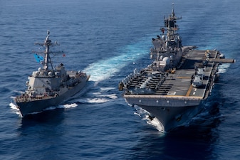 Amphibious assault ship USS Makin Island (LHD 8) conducts a photo exercise and replenishment-at sea with the Arleigh Burke-class destroyer USS Chung Hoon (DDG 93), March 15, 2023 in the South China Sea. The ability to refuel ships at sea demonstrates the mobility and sustainability provided by amphibious platforms that gives the Makin Island Navy/Marine Corps team an asymmetric advantage in a maritime environment. Chung Hoon and Makin Island of Amphibious Squadron (CPR) 7 are operating in the 7th Fleet area of operations, the U.S. Navy's largest forward-deployed numbered fleet, routinely operating with Allies and partners in preserving a free and open Indo-Pacific region.