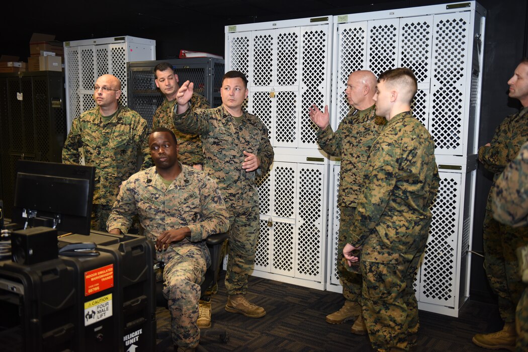 GySgt Robert Votta shows training materials to the CMC at MPIC