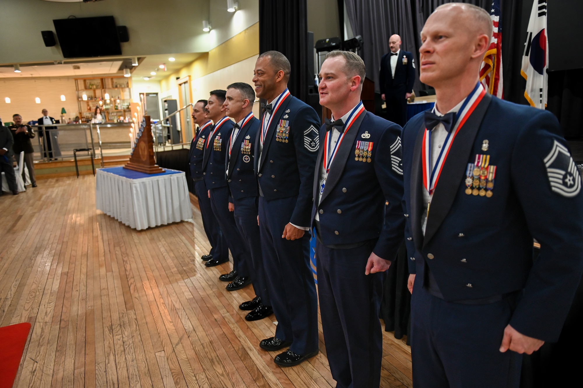 U.S. Air Force chief master sergeant selects pose for a group photo during a Chief Recognition Ceremony at Osan Air Base, Republic of Korea, March 17, 2023.