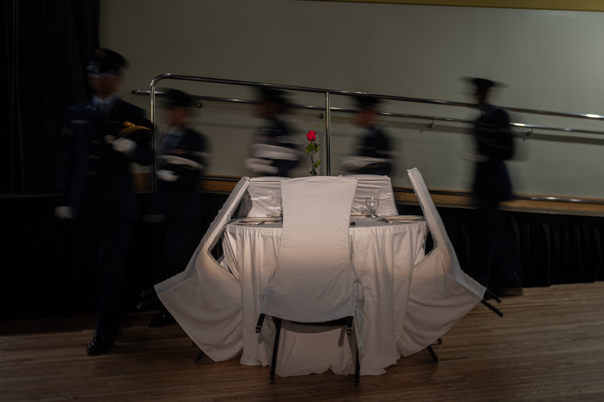 Members of the U.S. Air Force Honor Guard march around the missing man table, during a Chief Recognition Ceremony at Osan Air Base, Republic of Korea, March 17, 2023.