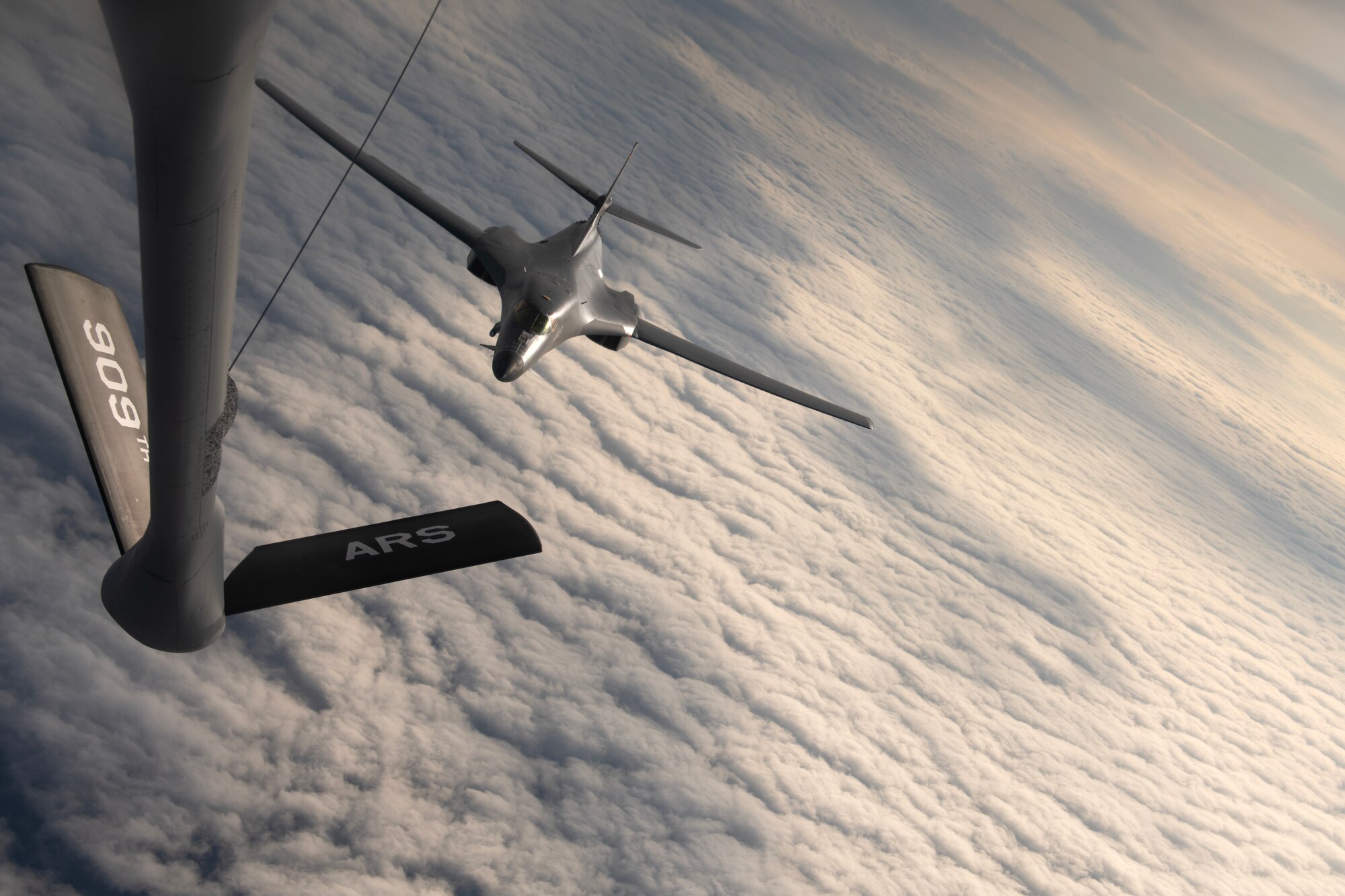 A U.S. Air Force 34th Expeditionary Bomb Squadron B-1B Lancer approaches a 909th Air Refueling Squadron KC-135 Stratotanker during a flight over the Pacific Ocean, March 19, 2023. Bomber missions contribute to joint force lethality and deter aggression in the Indo-Pacific by demonstrating the U.S. Air Force’s ability to operate anywhere in the world at any time in support of the National Defense Strategy. (U.S. Air Force photo by Senior Airman Jessi Roth)