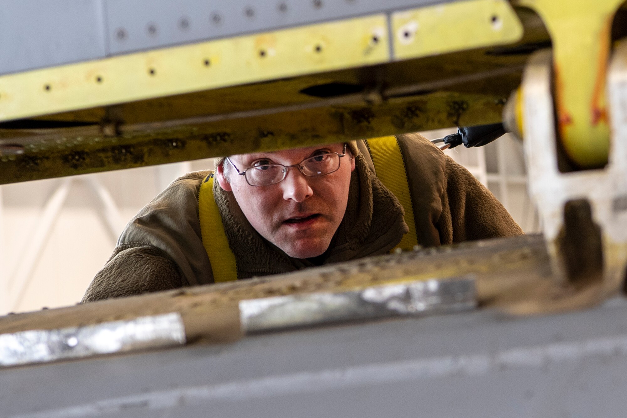 Tech. Sgt. Brian Morris, 434th Maintenance Squadron repair and reclamation technician, surveys the work area where faulty tail pins are located on aircraft 60-0314 on March 16, 2023. Grissom maintainers scrambled to replace pins prior to an upcoming runway closure. (U.S. Air Force photo by Douglas Hays)