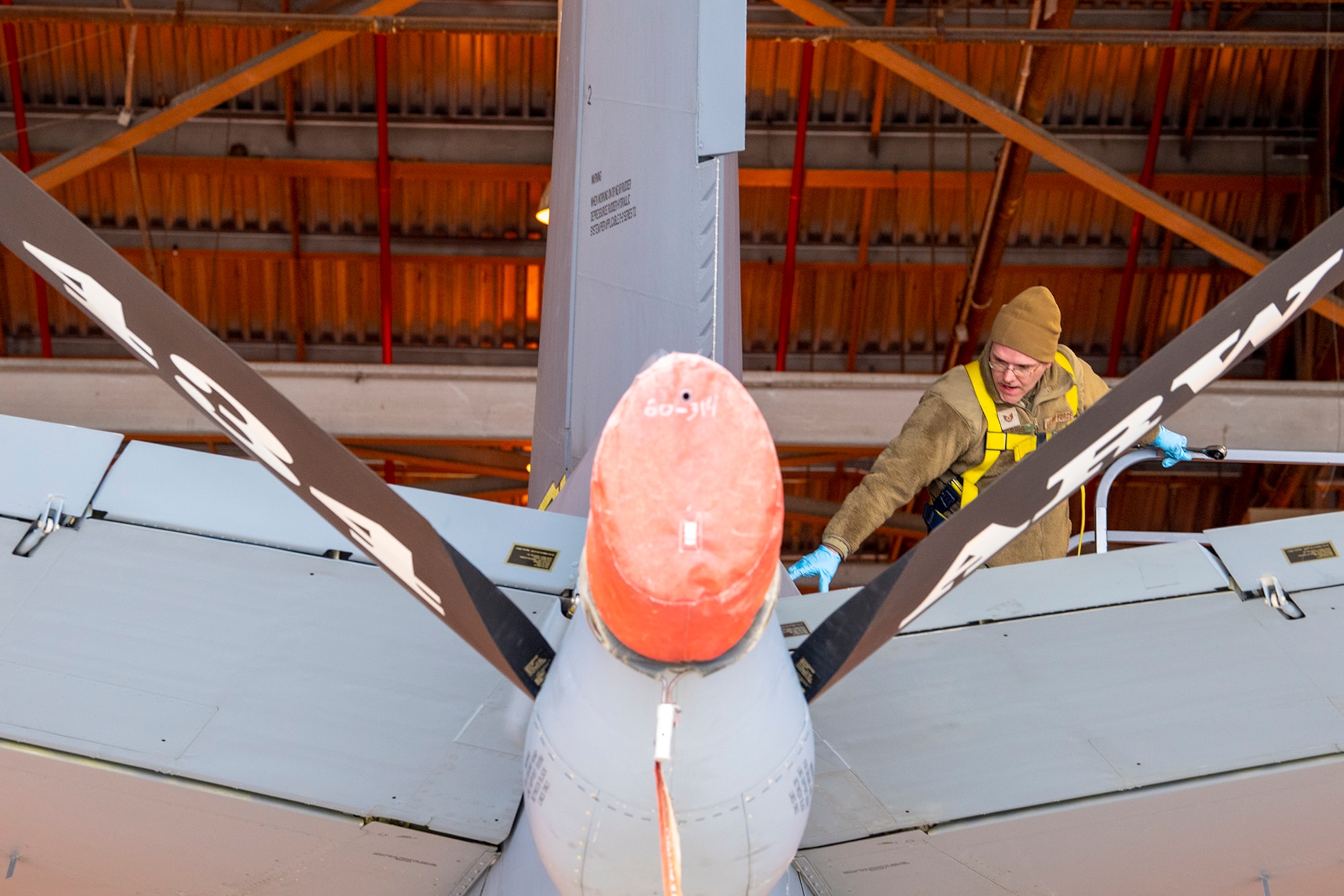 Tech. Sgt. Brian Morris, 434th Maintenance Squadron repair and reclamation technician, moves to remove a tail pin on aircraft 60-0314 on March 16, 2023. The pin replacement was mandated by a time compliant technical order issued recently that grounded KC-135R Stratotankers that didn’t meet required specifications. (U.S. Air Force photo by Douglas Hays)