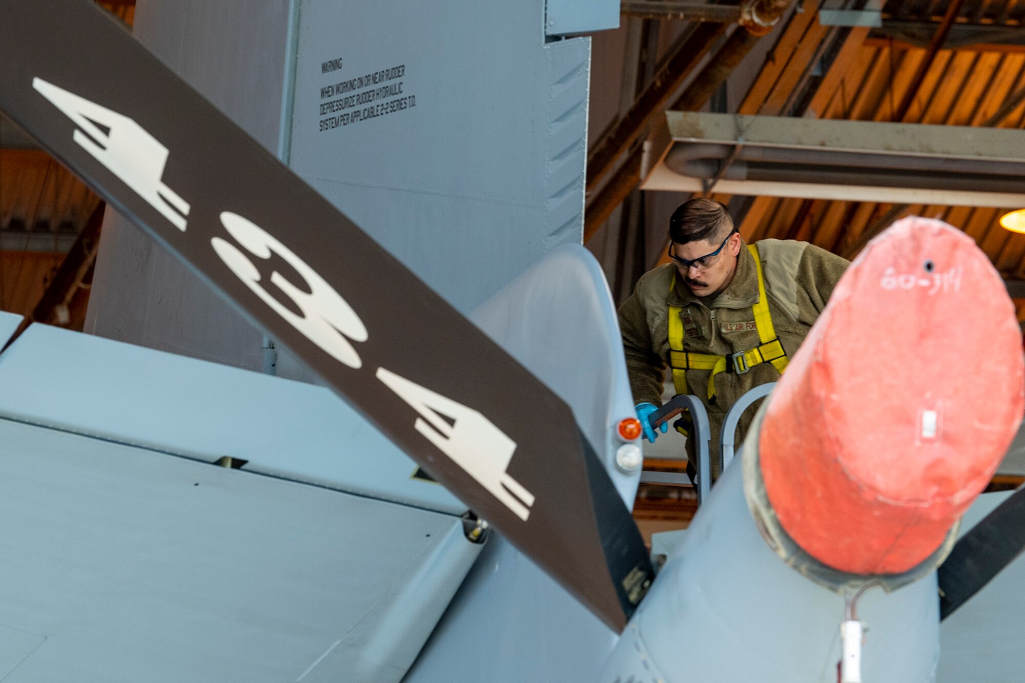 Tech. Sgt. Joel Pfeiffer, 434th Maintenance Squadron repair and reclamation technician, moves to remove a tail pin on aircraft 60-0314 on March 16, 2023. The pin replacement was mandated by a time compliant technical order issued recently that grounded KC-135R Stratotankers that didn’t meet required specifications. (U.S. Air Force photo by Douglas Hays)