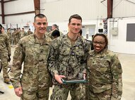 Walter Reed National Military's Medical Center (WRNMMC) Troop Command U.S. Army Command Sergeant Major (CSM) Scott Pierce U.S. Army Col. Sabrina Thweatt pose with Hospital Corpsman 3rd Class Weston Moore following the Expert Field Medical Badge (EFMB) award ceremony held at Fort A.P. Hill, VA, Mar. 17.

Moore earned the U.S. Army Expert Field Medical Badge (EFMB) and earned “Top Doc” by finishing with the highest score.

The EFMB is a special skill award that recognizes exceptional competence and outstanding performance by Army field medical personnel.

(Photo courtesy Walter Reed National Military Medical Center)