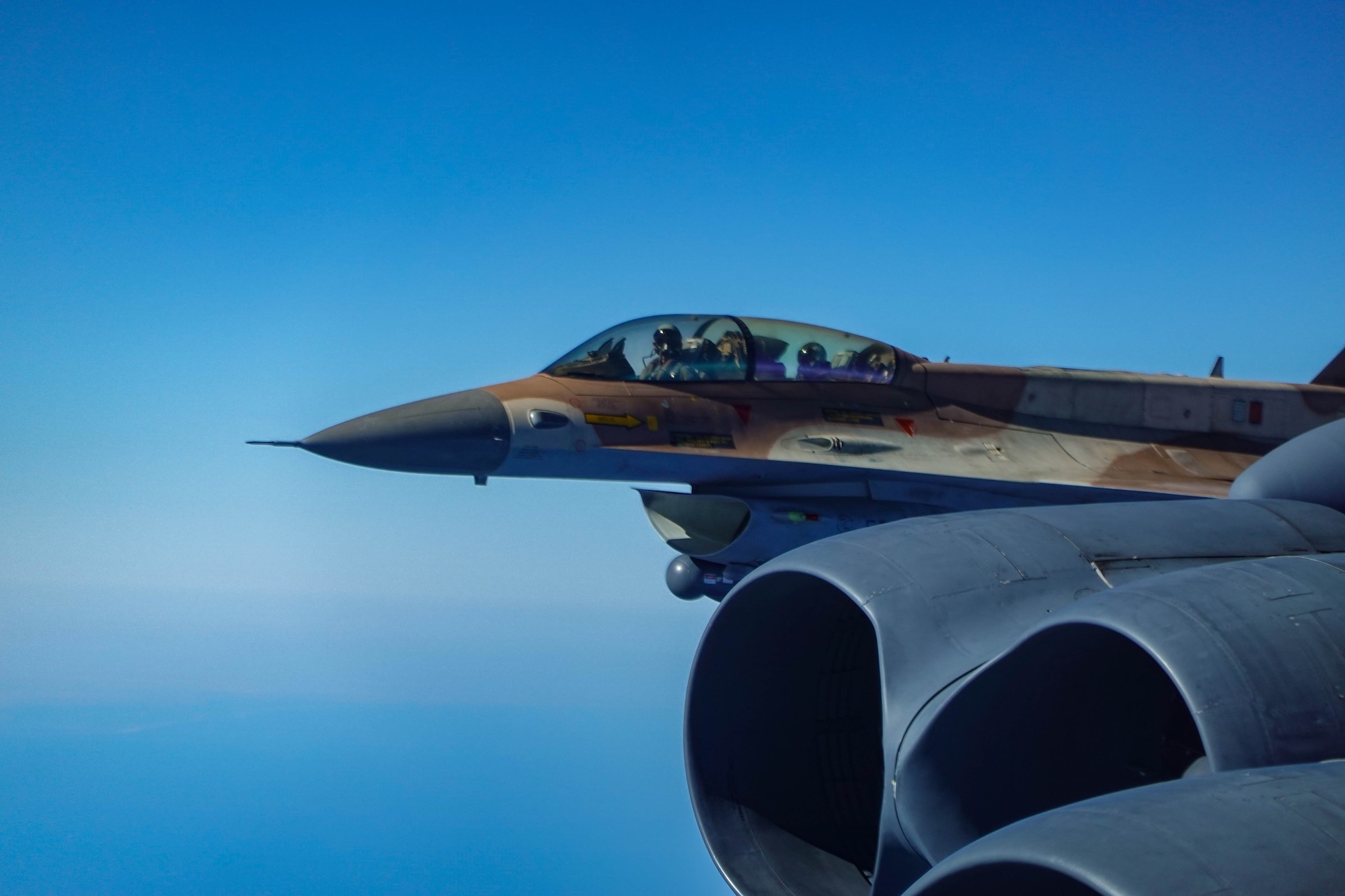 A Jordanian Air Force F-15 flies in formation with a B-52H Stratofortress assigned to the 23rd Expeditionary Bomb Squadron in the Central Command area of responsibility March 12, 2023. Bomber Task Force missions familiarize aircrew with air bases and operations in different geographic combatant command areas of operations. (U.S. Air Force courtesy photo)