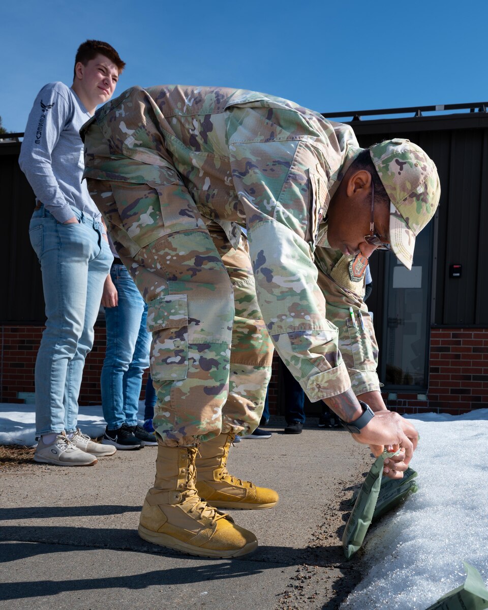 Tech. Sgt. Carl Bostic, 934 Airlift Wing Development and Training Flight coordinator, checks the seal on a flameless ration heater included in all meals-ready-to-eat outside of the D&TF building at the Minneapolis-St. Paul Air Reserve Station, Minnesota, March 5, 2023. Bostic is in charge of training for all D&TF members. (U.S. Air Force photo by Senior Airman Victoriya Tarakanova)