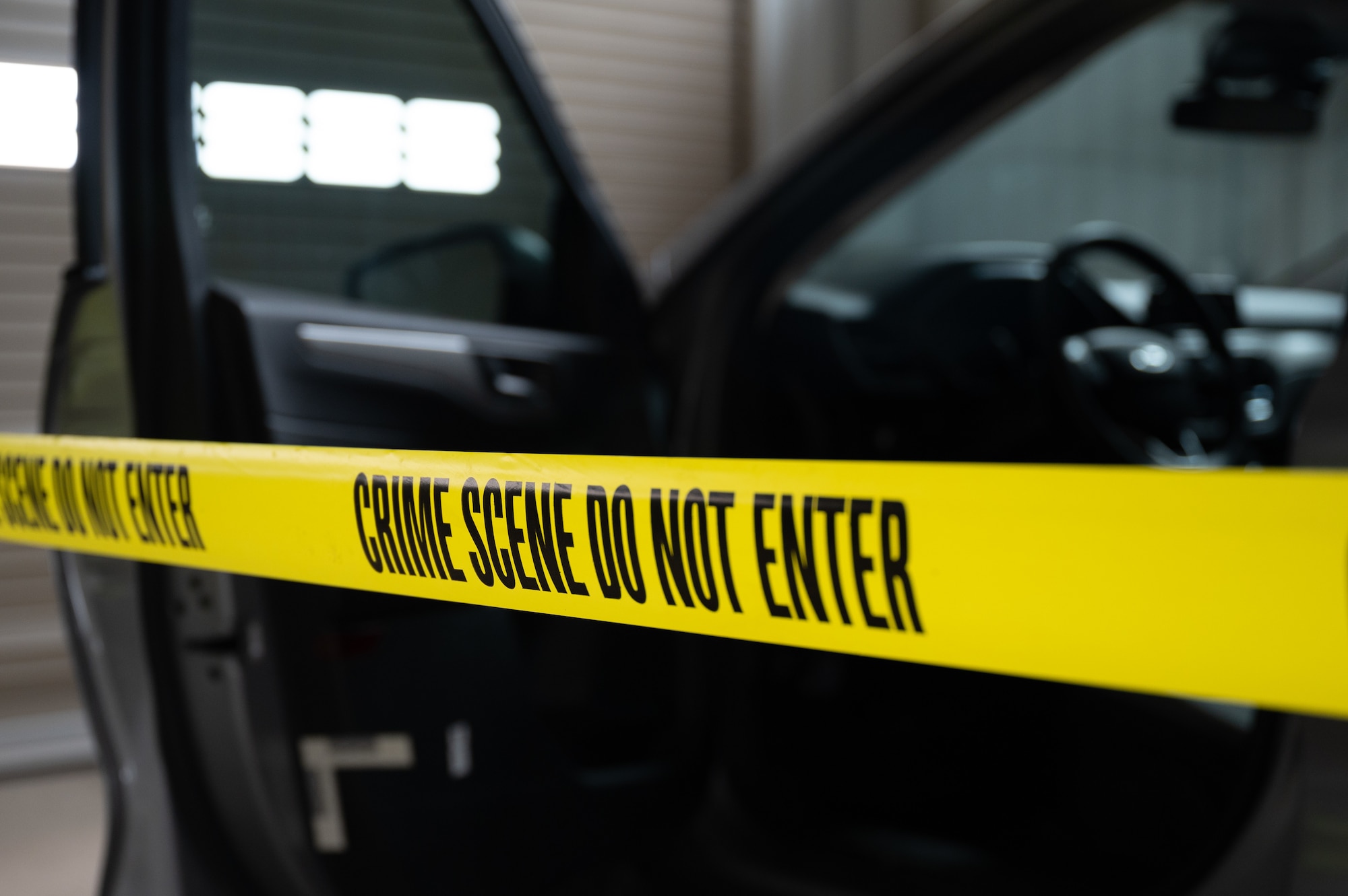 Yellow crime scene tape is used in a simulated investigation March 9, 2023, at McConnell Air Force Base, Kansas. The Air Force Office of Special Investigations handles serious offenses including espionage, terrorism, drug use, and other illegal activities that undermine the mission of the Department of Defense. (U.S. Air Force photo by Senior Airman Zachary Willis)