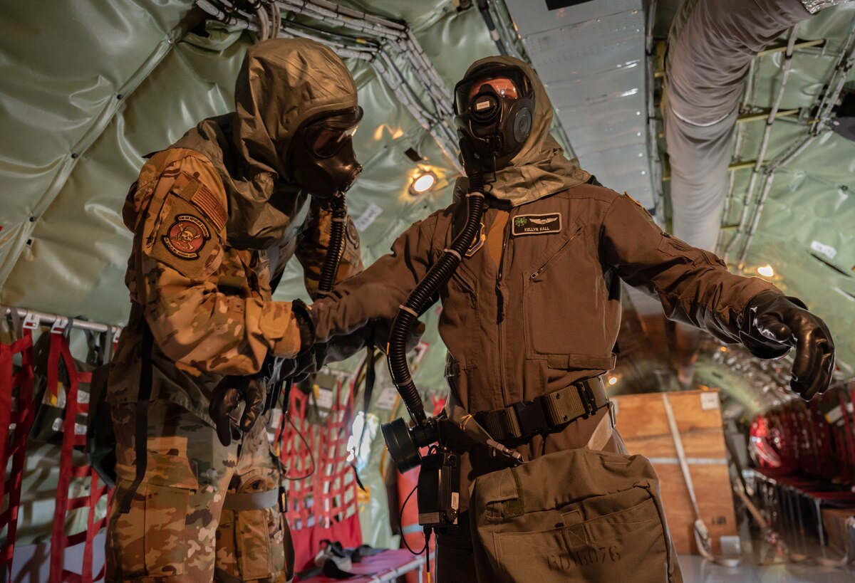KC-135 Stratotanker aircrew members assigned to the 63rd Air Refueling Squadron don Mission Oriented Protective Posture gear prior to disembarking from the aircraft in an exercise on MacDill Air Force Base, Fla,, Feb. 8, 2023. Simulating an enemy attack allows aircrew to practice emergency procedures and ensure full-spectrum readiness. (U.S. Air Force photo by Tech. Sgt. Bradley Tipton)