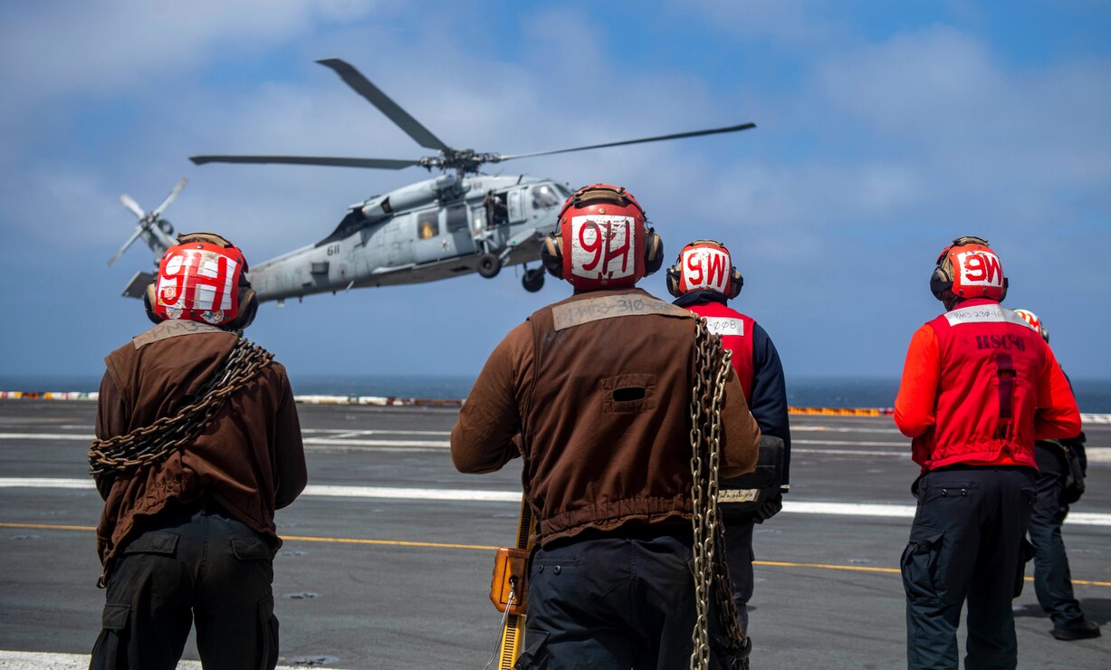 220614-N-YS933-1304 PACIFIC OCEAN (June 14, 2022) Sailors prepare to chock and chain an MH-60S Sea Hawk helicopter, from the “Indians” of Helicopter Sea Combat Squadron (HSC) 6, aboard the aircraft carrier USS Nimitz (CVN 68). Nimitz is underway in the U.S. 3rd Fleet area of operations. (U.S. Navy photo by Mass Communications Specialist 3rd Class Lorenzo Fekieta-Martinez)