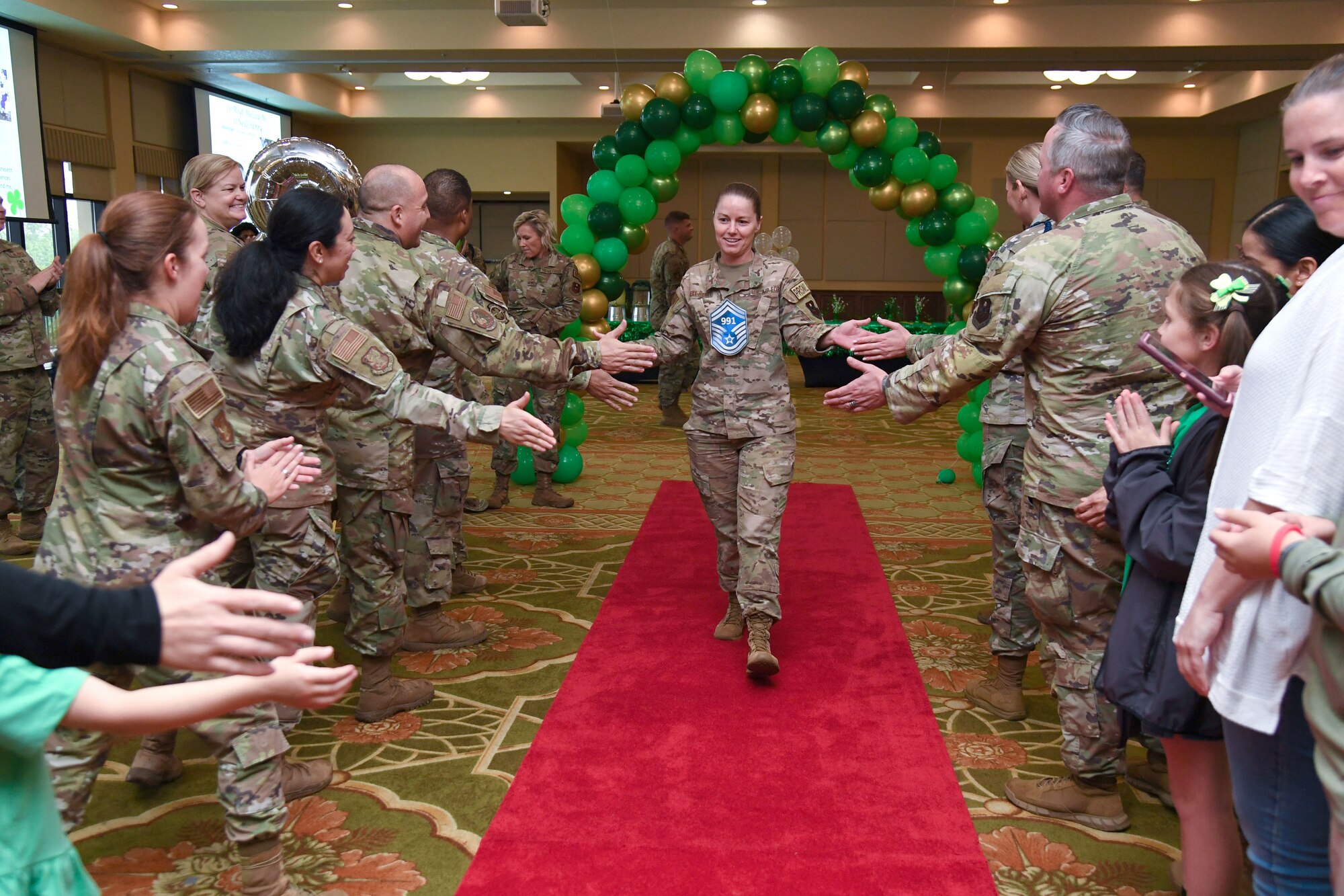 Keesler personnel and family members congratulate U.S. Air Force Master Sgt. Melissa O'Neill-Henry, Second Air Force personnel programs superintendent, during the Senior Master Sergeant Promotion Release Ceremony inside the Bay Breeze Event Center at Keesler Air Force Base, Mississippi, March 17, 2023.