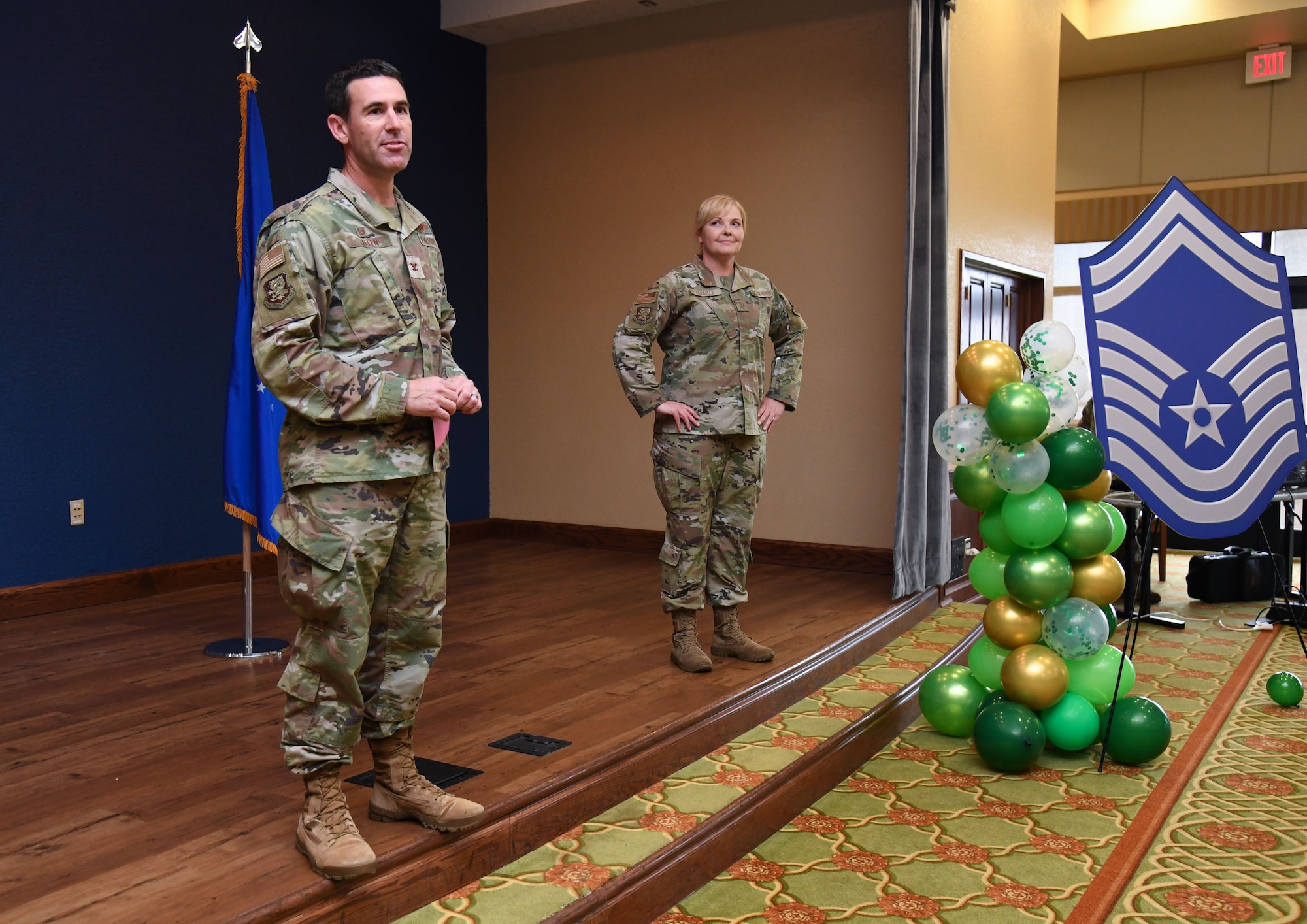 U.S. Air Force Col. Jason Allen, 81st Training Wing commander, delivers remarks while Chief Master Sgt. Sarah Esparza, 81st TRW command chief, stands by during the Senior Master Sergeant Promotion Release Ceremony inside the Bay Breeze Event Center at Keesler Air Force Base, Mississippi, March 17, 2023.