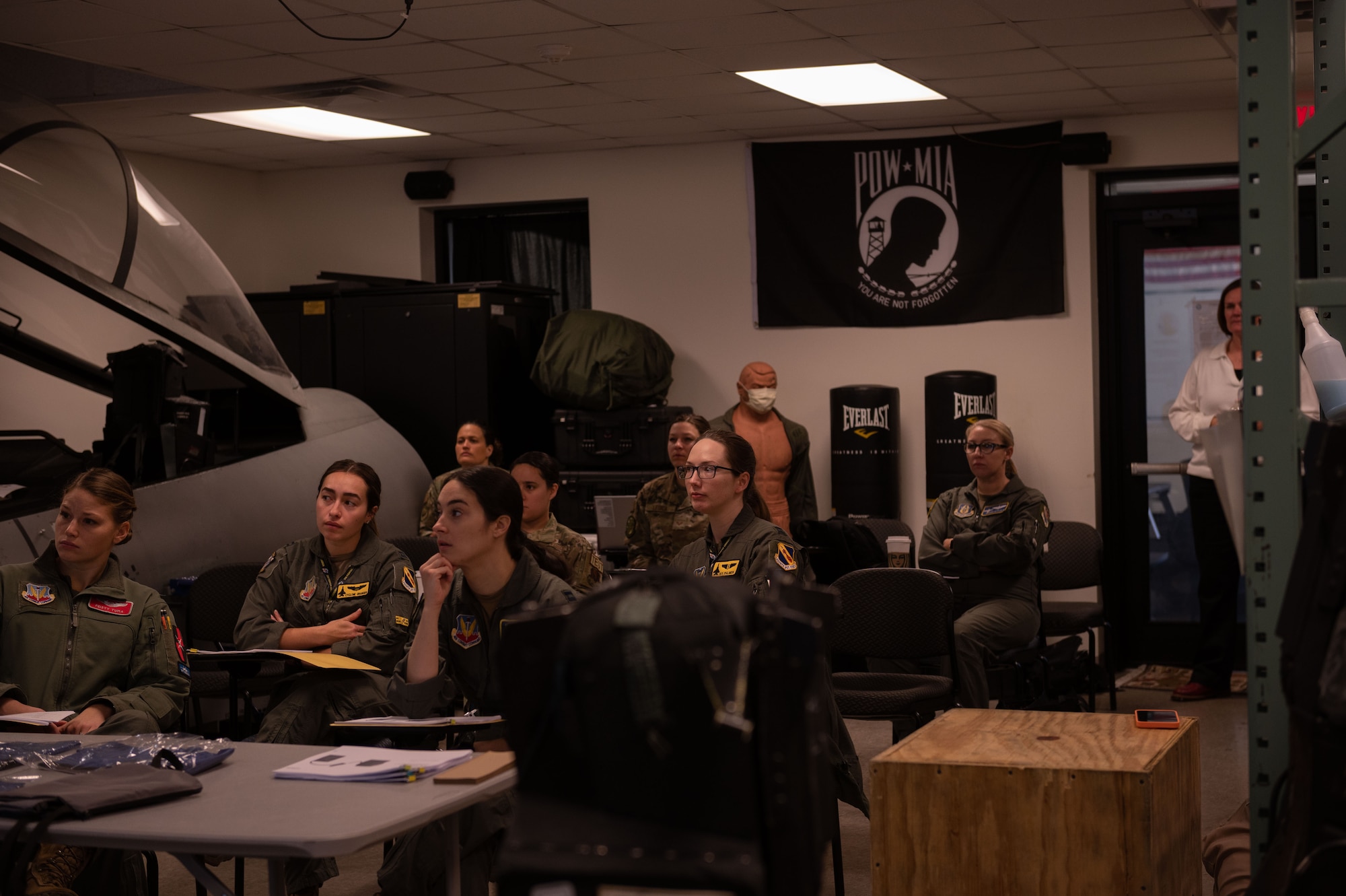 Airmen assigned to the 4th Fighter Wing sit in a pre brief before the first ground test beings for Airus in-flight bladder relief system at Seymour Johnson Air Force Base, North Carolina, Feb. 13, 2023. Seymour Johnson Air Force Base is first of many to ground test this new in-flight bladder relief system for female pilots. (U.S. Air Force photo by Airman 1st Class Rebecca Sirimarco-Lang)