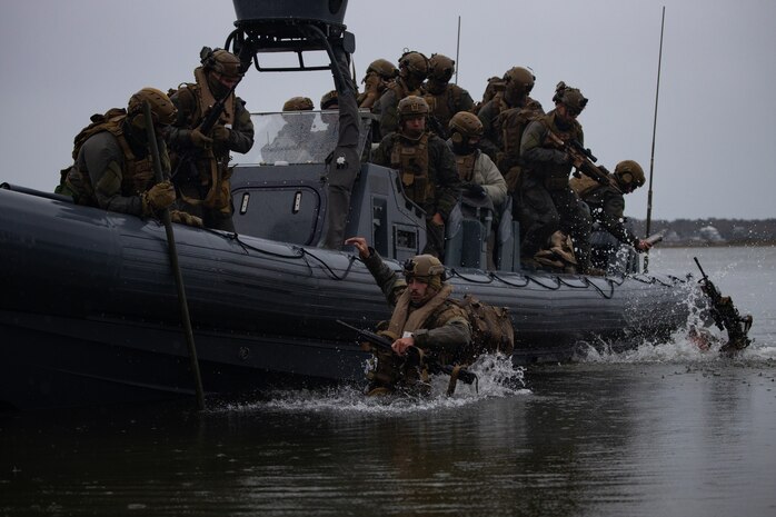 U.S. Marines with Charlie Company, Battalion Landing Team 1/6, 26th Marine Expeditionary Unit disembark small boats in preparation for a simulated raid as part of MEU Exercise III on Camp Lejeune, North Carolina, March 13, 2023. BLT 1/6 continues to enhance rigid-hulled inflatable boat readiness through conducting on and off and shore to shore drills prior to deployment. The 11m RHIBs provide a high-speed, long –range, low-signature combatant craft capable of projecting and recovering Marines for a variety of missions.