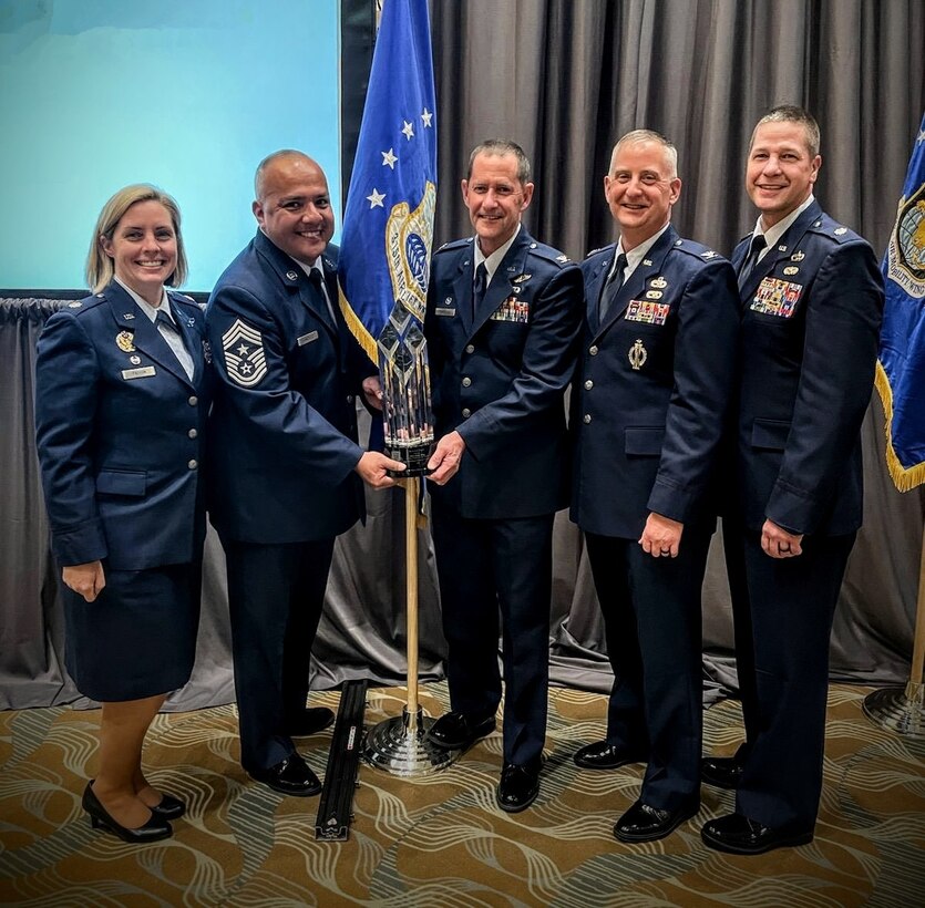 (from left) Lt. Col. Diane Patton, 315th Operation Group commander, Chief Master Sgt. Joe Gonzalez, 315th Airlift Wing command chief, Col. John Robinson, 315 AW commander, Col. Brett Newman, 315th Maintenance Group commander, and Lt. Col. Robert Wengerter, 315th Mission Support Group commander, accept Raincross Trophy on behalf of the 315 AW, Joint Base Charleston, South Carolina, from the 4th Air Force, headquartered at March Air Reserve Base, California, March 20, 2023. The wing celebrated the 315 AW’s achievement at the 315 AW annual awards ceremony during the March Unit Training Assembly. (Courtesy photo)