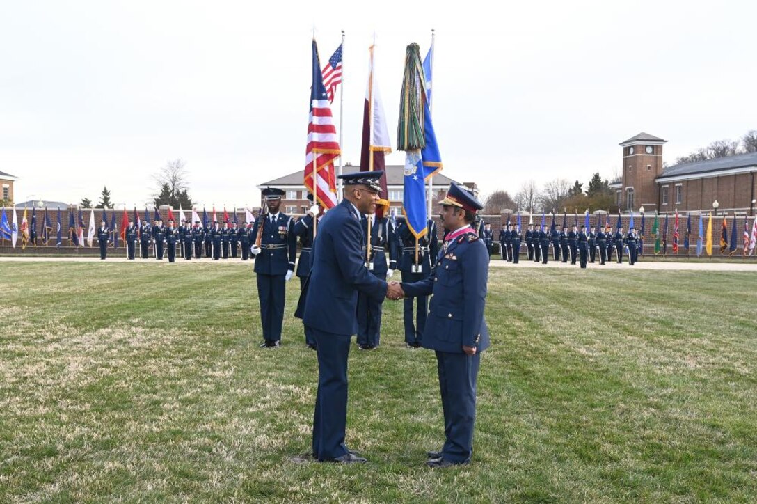 Air Force Chief of Staff Gen. CQ Brown, Jr. presents the Legion of Merit to Qatar Emiri Air Force Commander Maj. Gen Jassim Al-Mannai during a welcome ceremony at Joint Base Anacostia-Bolling, Washington, D.C., March 16, 2023. The full-honors event took place on the ceremonial parade field and included a performance by the Air Force band and display by the Air Force Honor Guard. (U.S. Air Force photo by Andy Morataya)