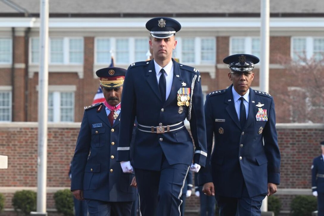 Air Force Chief of Staff Gen. CQ Brown, Jr. presents the Legion of Merit to Qatar Emiri Air Force Commander Maj. Gen Jassim Al-Mannai during a welcome ceremony at Joint Base Anacostia-Bolling, Washington, D.C., March 16, 2023. The full-honors event took place on the ceremonial parade field and included a performance by the Air Force band and display by the Air Force Honor Guard. (U.S. Air Force photo by Andy Morataya)