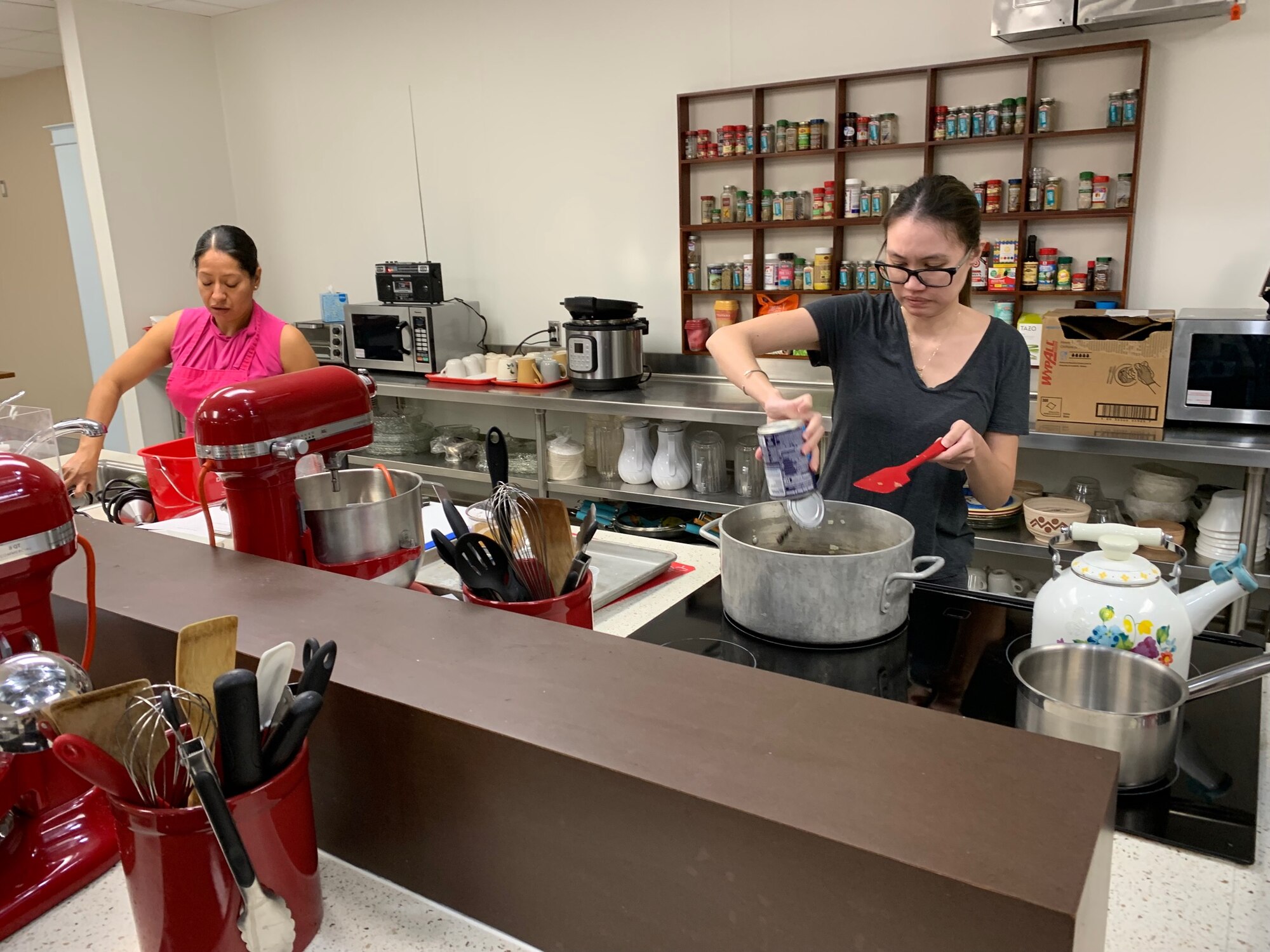 Maria Juarez-Cortez and TSgt Brittenny Rose cook black bean soup to complement other dishes being prepared. (Courtesy photo)