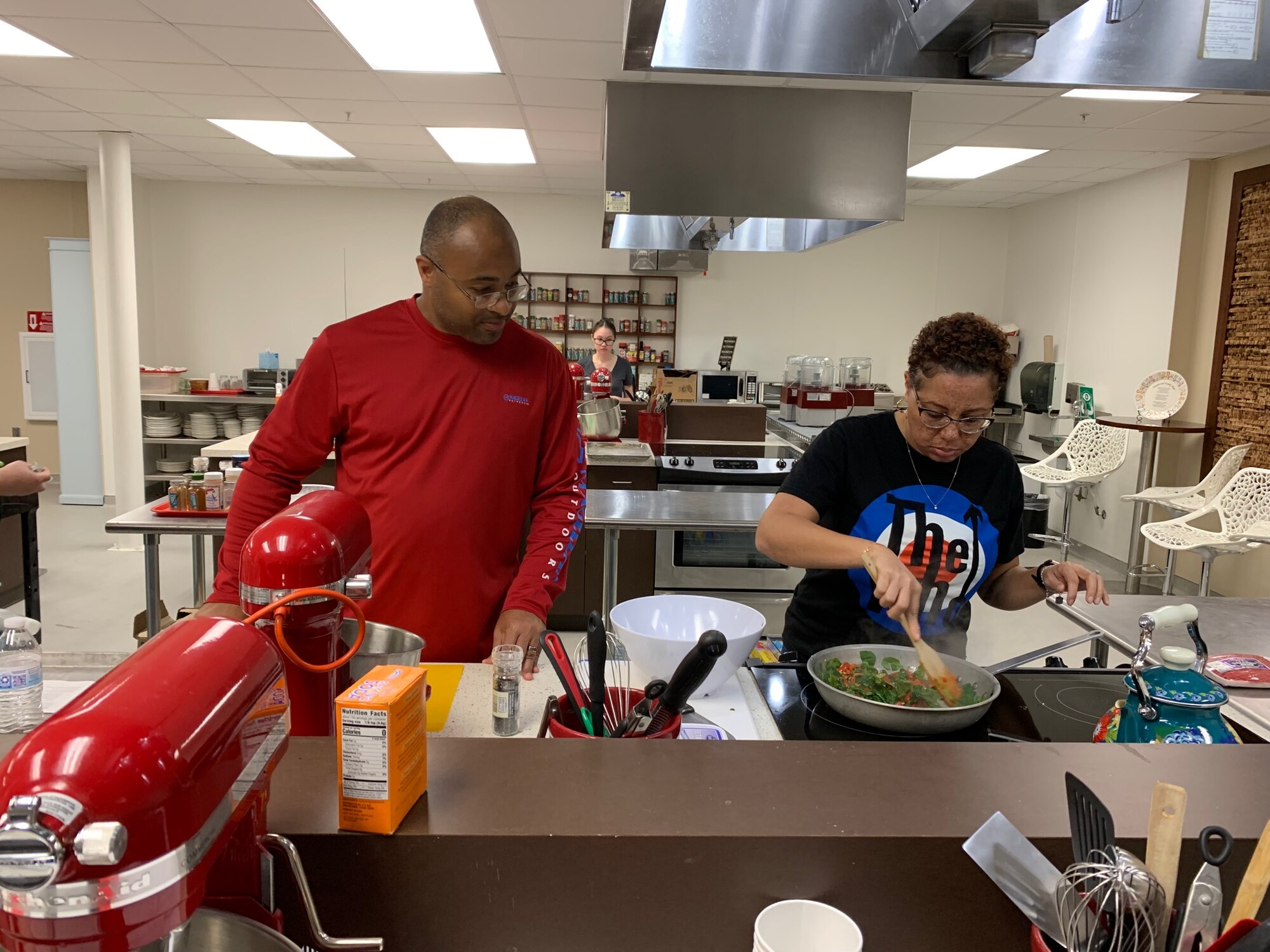 SMSgt Gregory Brown and Allison Brown cook several ingredients to prepare a Mediterranean stir fry dish. (Courtesy photo)