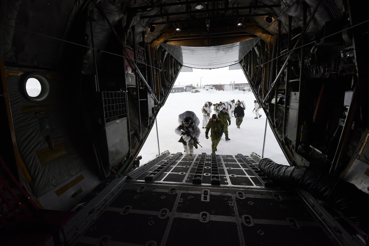 Soldiers board a plane.