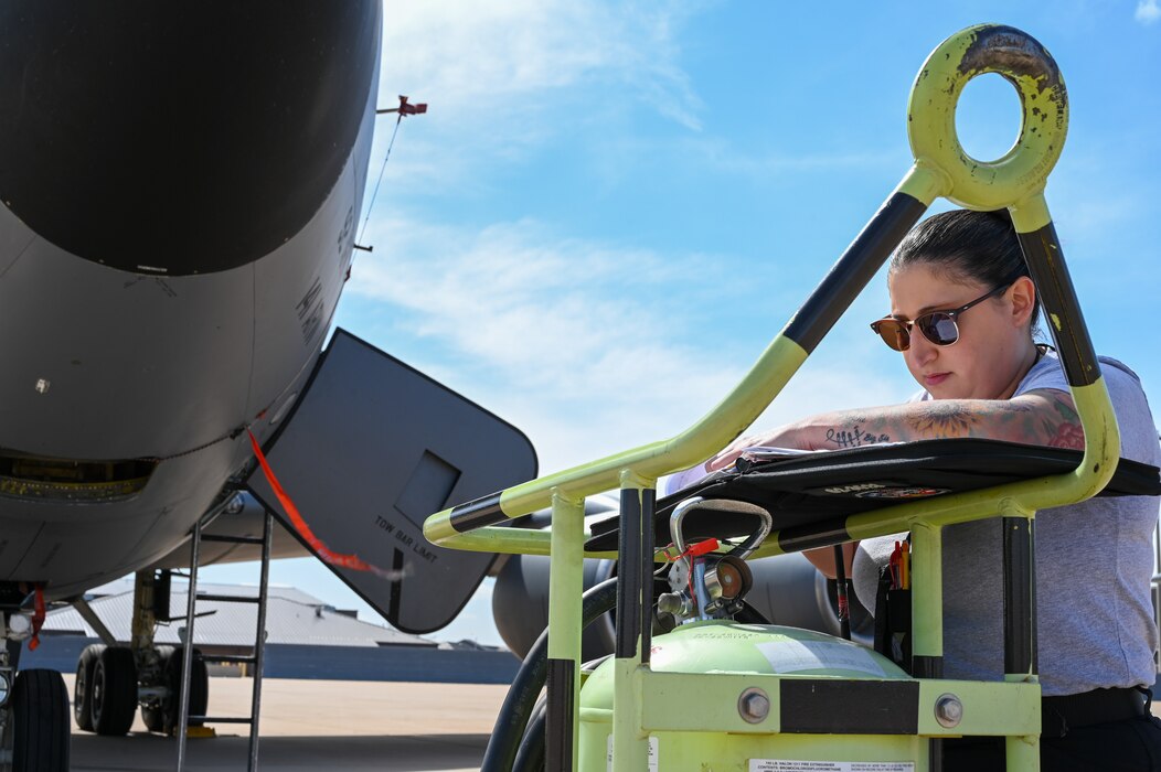 Julianne Martinez, 97th Maintenance Group KC-135 Stratotanker crew chief, checks her notebook before prepping a KC-135 for flight at Altus Air Force Base, Oklahoma, March 15, 2023. Martinez started her career at the 97th MXG in 2018 as an assisted crew chief. (U.S. Air Force photo by Senior Airman Kayla Christenson)