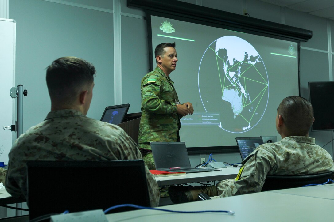 Australian Defense Force (ADF), Army Maj. Damien Morse, a logistics officer with ADF – Army School of Logistic Operations, briefs U.S. Marines on joint logistics at Marine Corp Logistics Operations Group, Marine Corps Air Ground Combat Center, Twentynine Palms, California, Jan. 9, 2023. The purpose of his visit was to increase logistics readiness and the efficiency of deploying units regarding the full spectrum of logistics capabilities corresponding to specific theaters of operations. (U.S. Marine Corps Photo by Cpl. Jonathan M. Forrest)