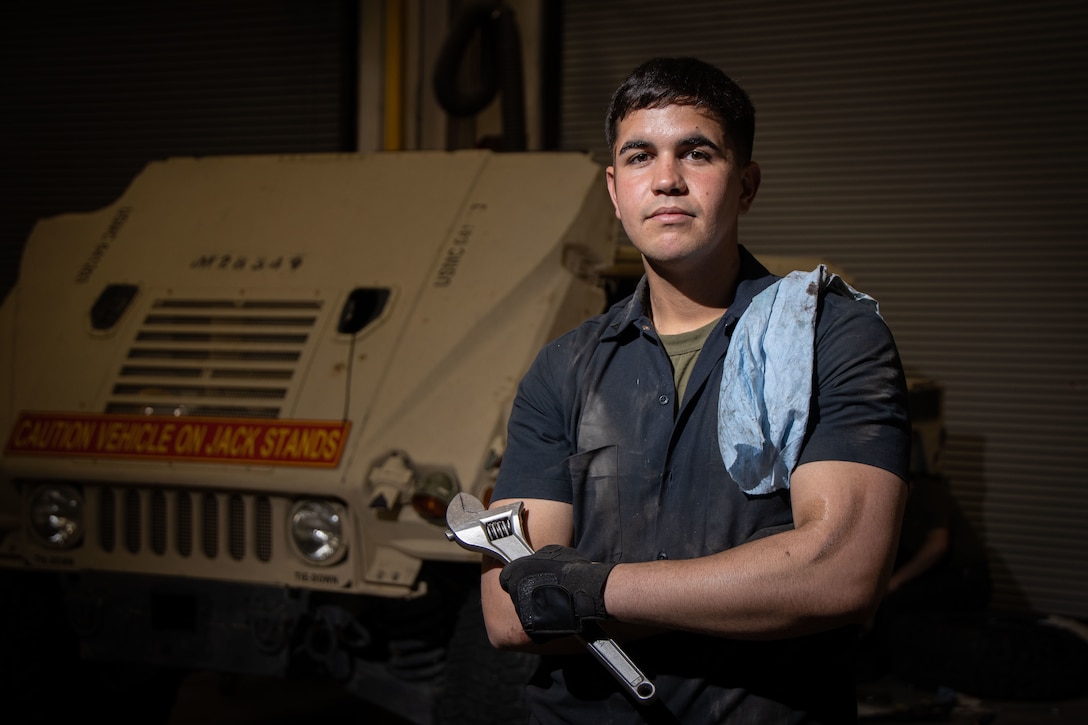 U.S. Marine Corps Lance Cpl. Jahdiel Moreraramos, automotive maintenance technician, Combat Logistics Battalion 7, 1st Marine Logistics Group, poses for a photo during vehicle maintenance at Marine Corps Air Ground Combat Center, California, March 7, 2023. Moreraramos, a Colon, Matanzas, Cuba Native, won the 1st quarter Marine of the Quarter award for his dedication to the Marine Corps and drive to better himself and his fellow Marines every day. (U.S. Marine Corps photo by Cpl. Makayla Elizalde)