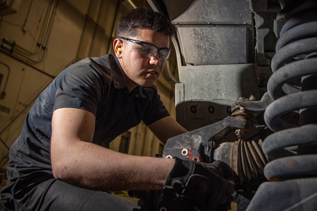 U.S. Marine Corps Lance Cpl. Jahdiel Moreraramos, automotive maintenance technician, Combat Logistics Battalion 7, 1st Marine Logistics Group, performs vehicle maintenance at Marine Corps Air Ground Combat Center, California, March 7, 2023. Moreraramos, a Colon, Matanzas, Cuba Native, won the 1st quarter Marine of the Quarter award for his dedication to the Marine Corps and drive to better himself and his fellow Marines every day. (U.S. Marine Corps photo by Cpl. Makayla Elizalde)