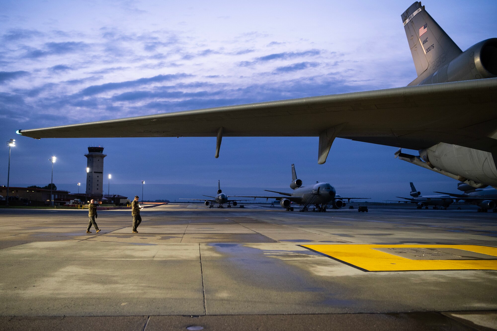 Two men inspect a plane