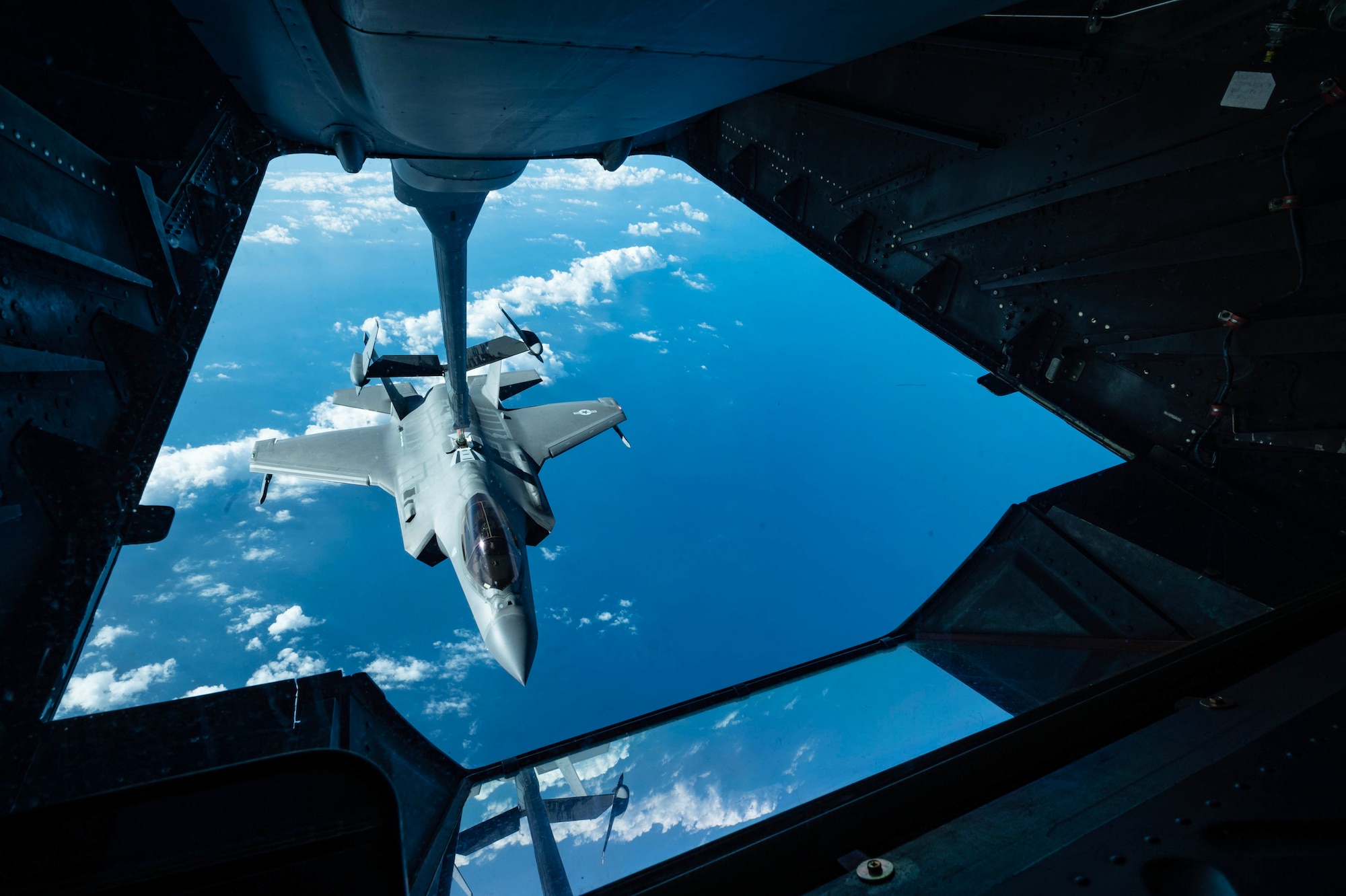 A plane refuels a jet on air